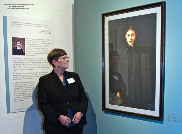 Joy M. Kiser Author of American's Other Audubon standing by portrait of Genevieve Estelle Jones at the reception of Nests, Eggs, Heartbreak & Beauty exhibition and book signing, Museum of American Bird Art at Mass Audubon, ©Mardi Welch Dickinson/Kymry GroupAll Rights Reserved.