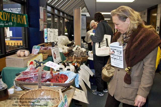Participant views the Northfordy Farm table. CTNOFA Winter Conference 2013, Wilton High School, Wilton, CT, ©Mardi Welch Dickinson/KymryGroup. All Rights Reserved.