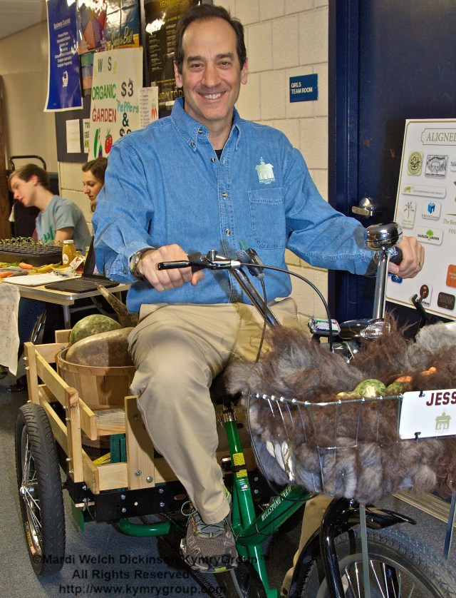 Jesse Fink, Owner, Millstone Farm, on his Tricycle made for Millstone Farm by Workman Cycle Facory, The Nation's oldest exsting Bike Maker since 1889. CTNOFA Winter Confdrence 2013, Wilton High School, Wilton, CT. ©Mardi Welch Dickinson/KymryGroup™ All Rights Reserved.