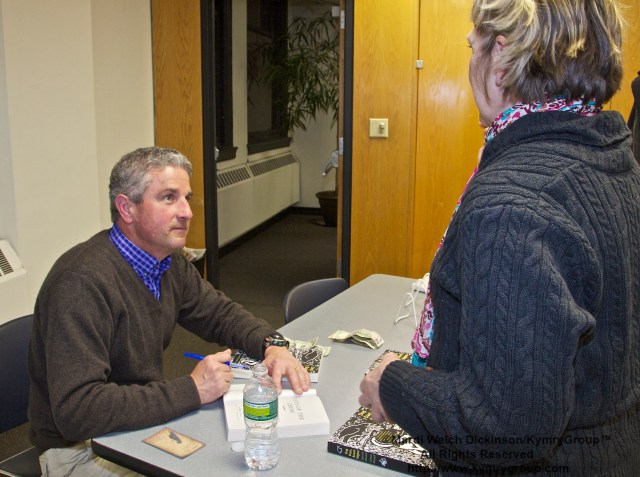 John Marzluff, Author, Gifts of the Crow. Book signing and talking with guest at his presentation at the New York Public Library Mid-Manhattan New York, NY. April 2, 2013. ©Mardi Welch Dickinson/Kymry Group. All Rights Reserved.