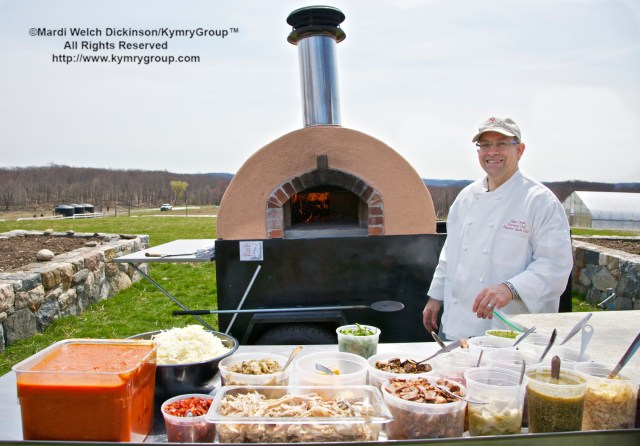Quint Smith, Executive Chef, Stamford Yacht Club serving lunch on a firedupkitchens mobil  wood-fired oven at Hilltop Hanover Farm. Chef Farm Tour & Luncheon, Slow Food Metro North on April 15, 2013. ©Mardi Welch Dickinson/KymryGroup™ All Rights Reserved.