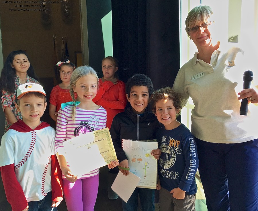 R. Gretchen Whitman, NJ Audubon Sanctuary Director, Nature Center of Cape May NJ Audubon with kids from New Jersey Center for the Book at the Cape May Fall Birding Festival Trade Show, Convention Hall, Cape May, NJ. ©Mardi Welch Dickinson All Rights Reserved.